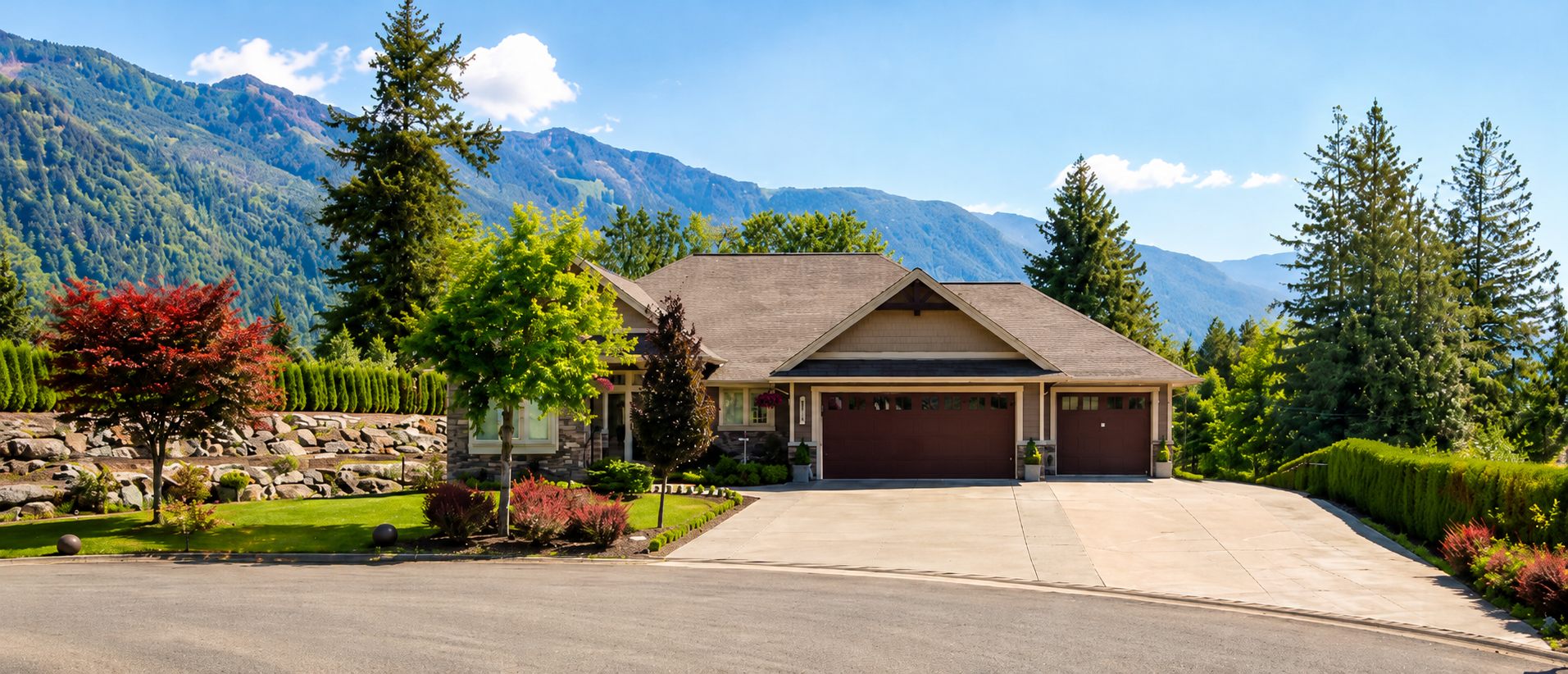 Rancher-style home with stone accents and triple garage